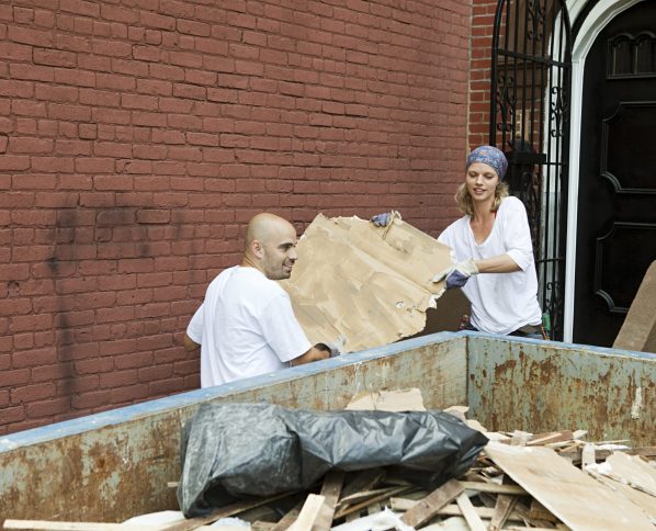 Two people working together on a community cleanup project